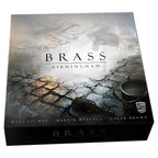 Front cover of Brass Birmingham board game box featuring moody cobblestone street artwork with designers Matt Tolman, Martin Wallace, and Gavan Brown credited.