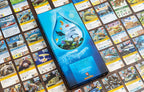 Marine Worlds Arknova expansion box displayed upright on a spread of colorful animal and action cards from the game.