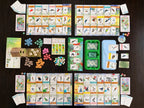 Wingspan Americas expansion fully laid out showing player mats with bird cards, egg tokens, food tokens, dice, bird feeder, and card trays on a dark table.