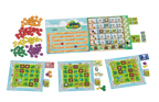 Juicy Fruits board game components spread showing colorful fruit tokens, scoring track, player boards, market board, and cards.