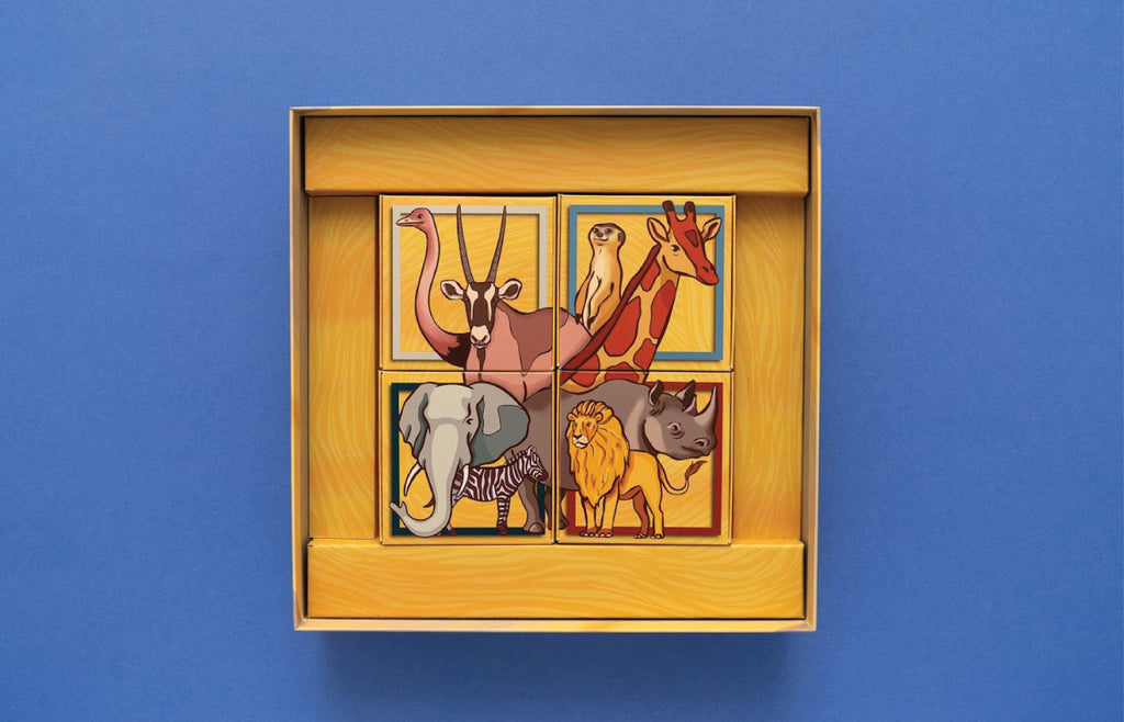 Savannah Park open box showing four illustrated animal puzzle tiles featuring an ostrich, oryx, meerkat, giraffe, elephant, zebra, lion, and rhino.