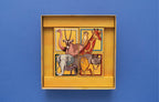 Savannah Park open box showing four illustrated animal puzzle tiles featuring an ostrich, oryx, meerkat, giraffe, elephant, zebra, lion, and rhino.