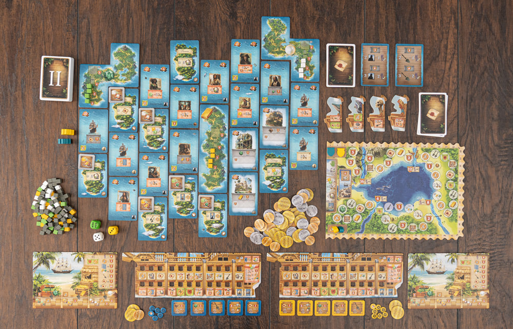 Pirates of Maracaibo full component spread showing island cards, player boards, coins, dice, and tokens laid out on a wooden surface.