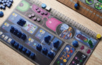 Gaia Project Terrans faction board in play, covered with blue spaceships, mines, and purple resource tokens on a wooden table.