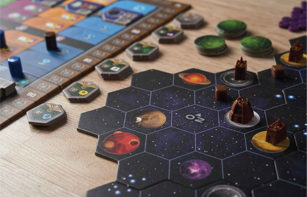 Gaia Project board game mid-game close-up showing space hex tiles with planets, faction tokens, and 3D building miniatures on a wooden table.